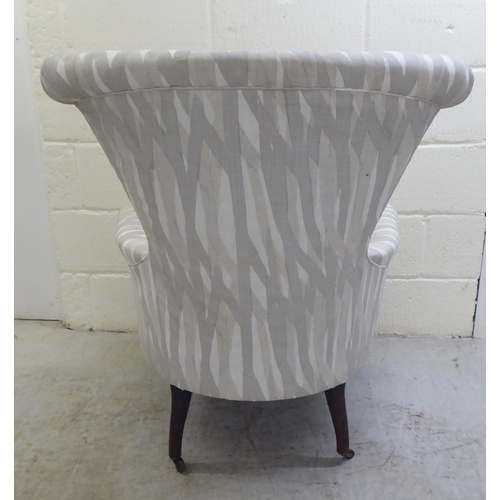 41 - A late Victorian and later fabric upholstered bedroom chair, raised on cabriole forelegs and casters