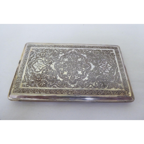 416 - White metalware, viz. an engraved, folding cigarette case; a bowl with armorial devises, raised on p... 