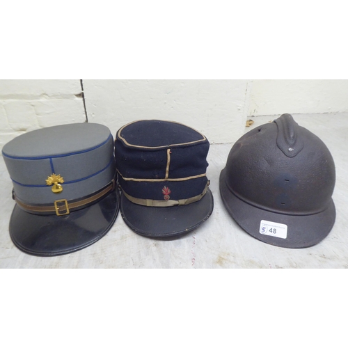 48 - Two World War II firefighters helmets; and three contemporary peaked caps(Please Note: this lot is s... 