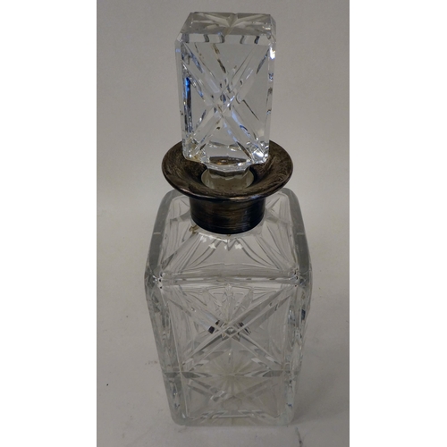 56 - An Asprey glass decanter with a silver collar