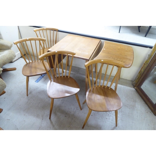 70 - An Ercol stained beech drop-leaf table, raised on tapered legs  27