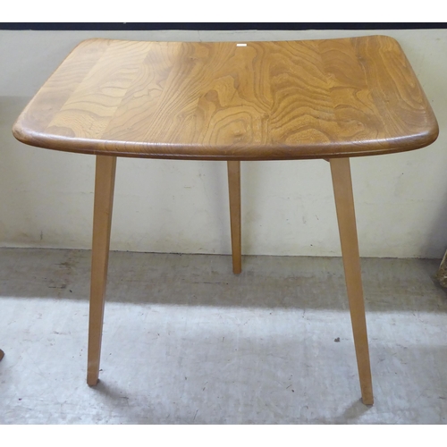 70 - An Ercol stained beech drop-leaf table, raised on tapered legs  27