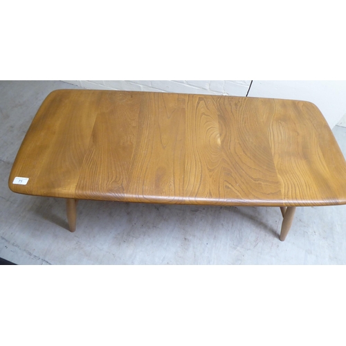 71 - An Ercol lozenge shaped beech and elm coffee table, raised on elliptically turned legs, united by a ... 