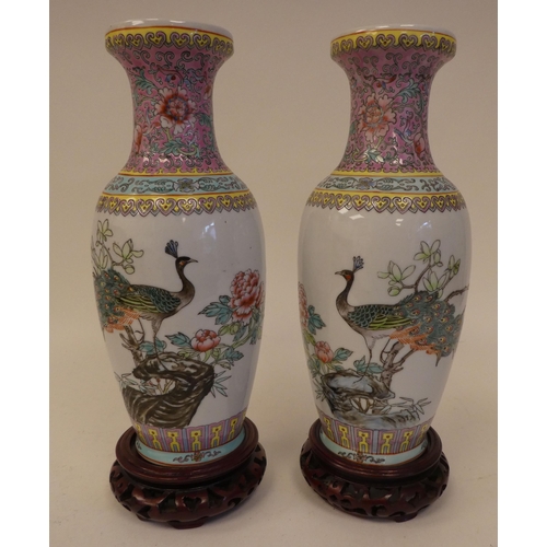 78 - Three 20thC Chinese porcelain vases on stands, each decorated with figures in a landscape  one ... 