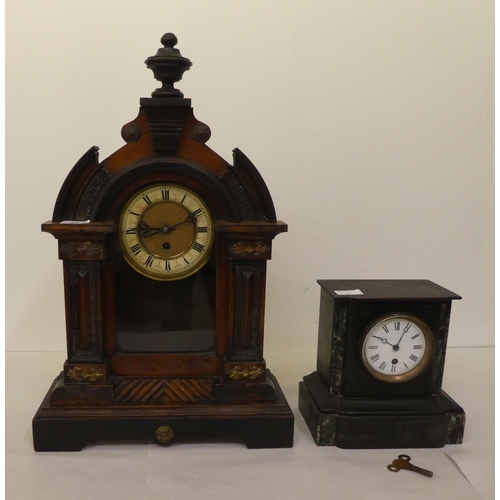 94 - An early 20thC American mantel timepiece, the pine case finished in a variety of woods; the movement... 