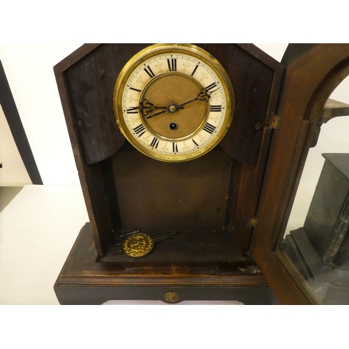 94 - An early 20thC American mantel timepiece, the pine case finished in a variety of woods; the movement... 