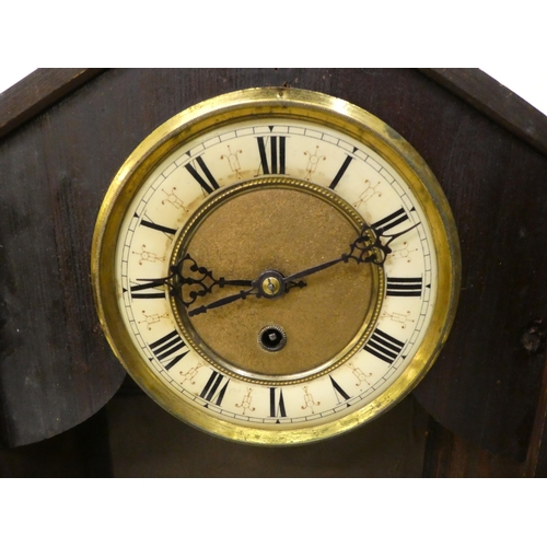 94 - An early 20thC American mantel timepiece, the pine case finished in a variety of woods; the movement... 