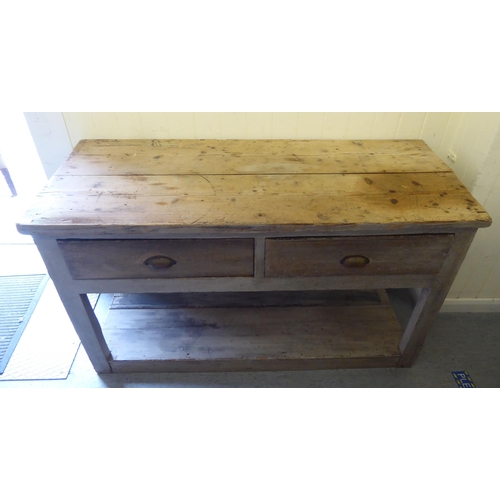 46 - A 20thC rustic and overpainted pine farmhouse style, two drawer dresser, raised on block legs, unite... 