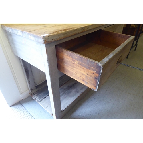 46 - A 20thC rustic and overpainted pine farmhouse style, two drawer dresser, raised on block legs, unite... 