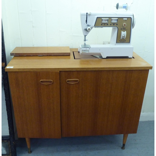 93 - A Singer sewing machine within a teak cabinet  30