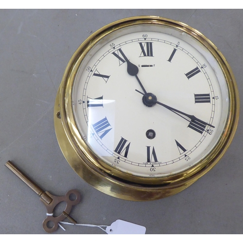 108 - A 20thC lacquered brass cased, bulkhead timepiece of drum design; the movement with sweeping seconds... 