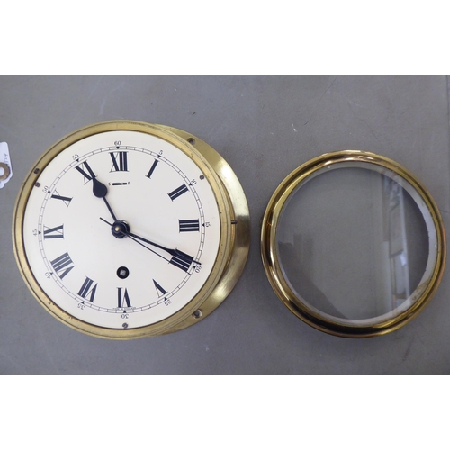 108 - A 20thC lacquered brass cased, bulkhead timepiece of drum design; the movement with sweeping seconds... 