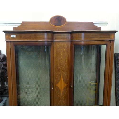 406 - An Edwardian satinwood string inlaid mahogany and marquetry display cabinet with a low upstand, over... 