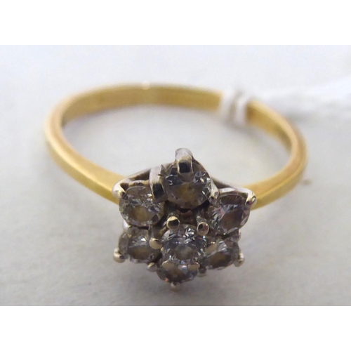 434 - An 18ct bi-coloured metal diamond cluster ring