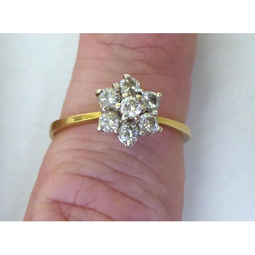 434 - An 18ct bi-coloured metal diamond cluster ring