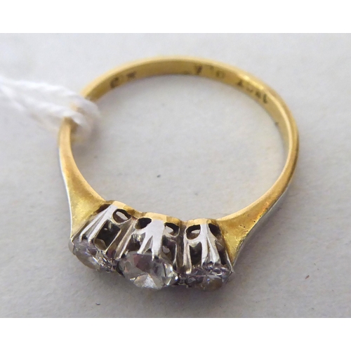 437 - An 18ct bi-coloured gold three stone diamond ring 