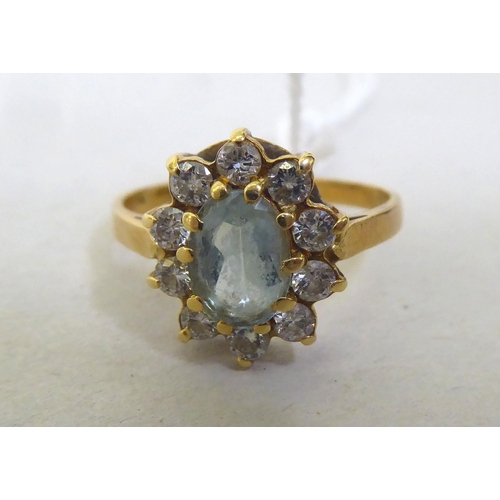 438 - An 18ct gold aquamarine cluster ring 