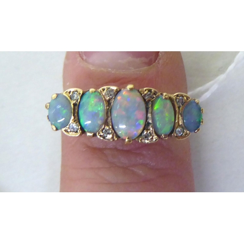 439 - A 9ct gold five opal stone and diamond set ring