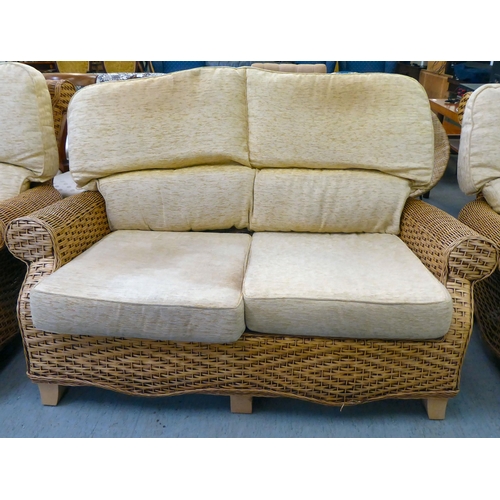 83 - A three piece caned conservatory suite, comprising a settee and two armchairs