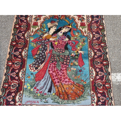 280 - An Afghan silk pictorial rug, decorated with a romantic couple, bordered by floral designs, on a mul... 