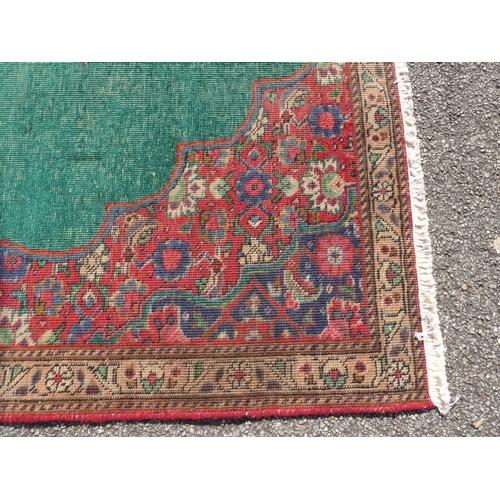 277 - An Iranian rug, on a red and green ground  56