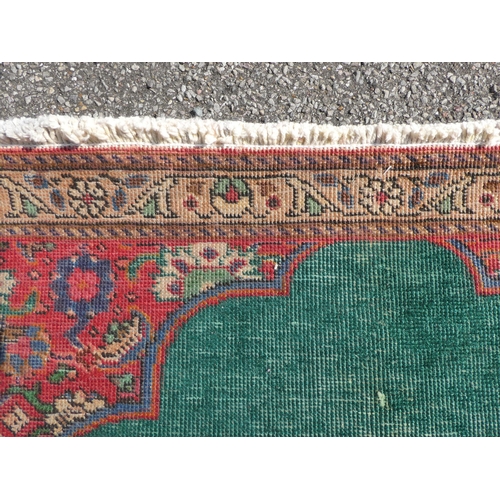 277 - An Iranian rug, on a red and green ground  56