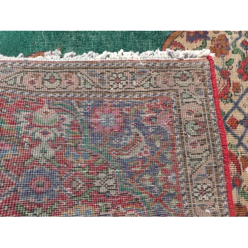 277 - An Iranian rug, on a red and green ground  56