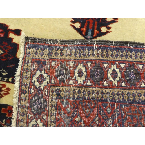 274 - A Persian rug, decorated with a central medallion, on a beige and maroon ground  64