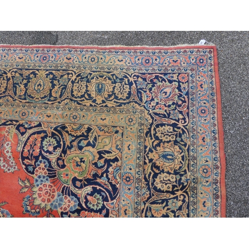 285 - An antique Kashan carpet, decorated with mainly floral designs, on a red ground  144