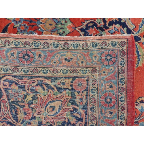 285 - An antique Kashan carpet, decorated with mainly floral designs, on a red ground  144