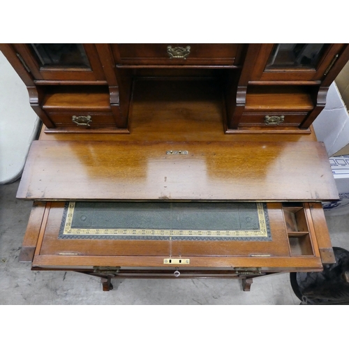 106 - An Edwardian mahogany one-piece writing desk, the desk top with glazed and drawer sections, incorpor... 