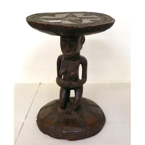 107 - An African carved wooden stool, fashioned as a native woman, on a circular base  16