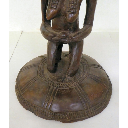 107 - An African carved wooden stool, fashioned as a native woman, on a circular base  16