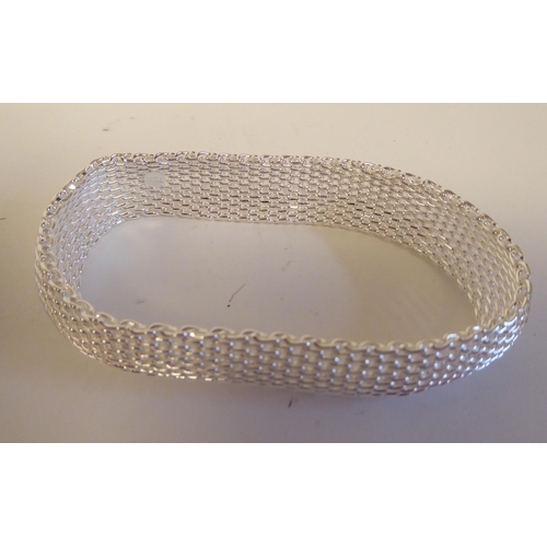 110 - Approx. sixteen modern silver coloured metal, flexible, non expanding, wide ring link bracelets ... 