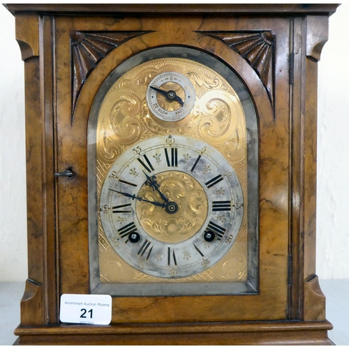 21 - A late 19thC walnut cased bracket clock, having an arched pediment, finials and fretworked flanks, o... 