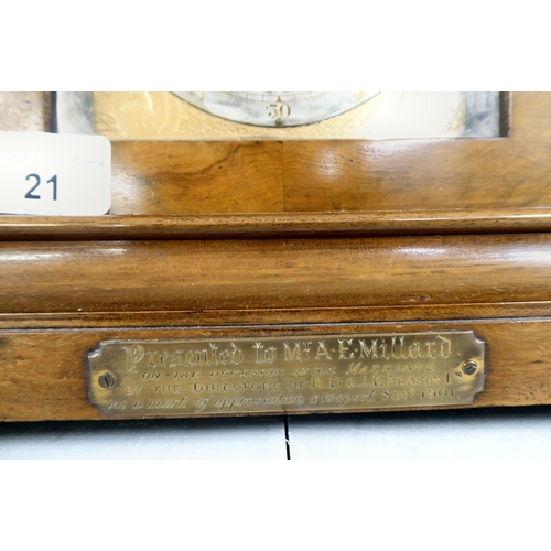 21 - A late 19thC walnut cased bracket clock, having an arched pediment, finials and fretworked flanks, o... 