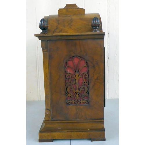 21 - A late 19thC walnut cased bracket clock, having an arched pediment, finials and fretworked flanks, o... 