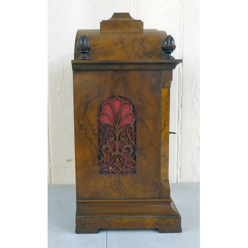 21 - A late 19thC walnut cased bracket clock, having an arched pediment, finials and fretworked flanks, o... 