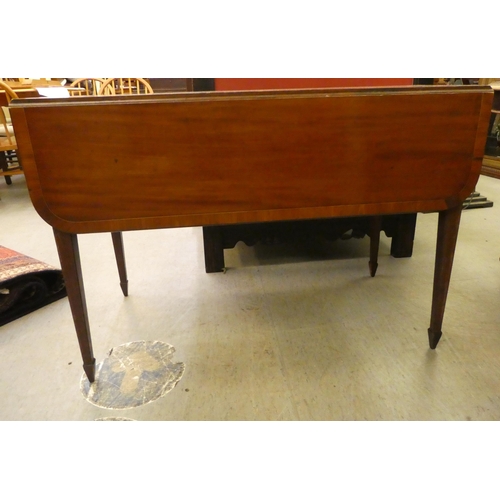 256 - A late 19thC satin mahogany and crossbanded Pembroke table, the top with round corners, over an end ... 