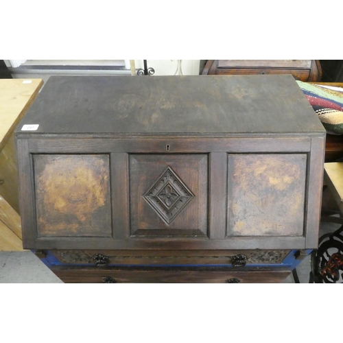 257 - A mid 20thC oak bureau with a fall flap, over three long drawers, raised on bracket feet  39