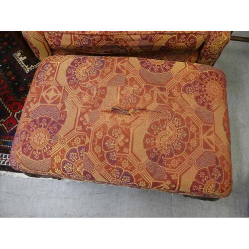 261 - A modern orange and red floral fabric upholstered wingback arm chair, raised on cabriole legs; and a... 