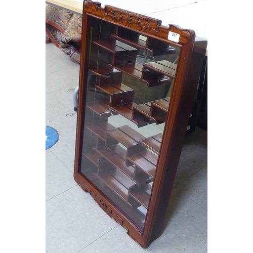 267 - A modern rosewood Shodana wall cabinet, the glazed door enclosing tiered shelves  31