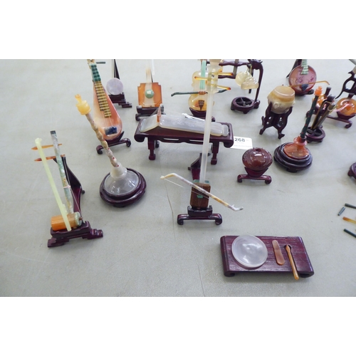 268 - Modern jade coloured and hardstone musical instruments with individual rosewood stands