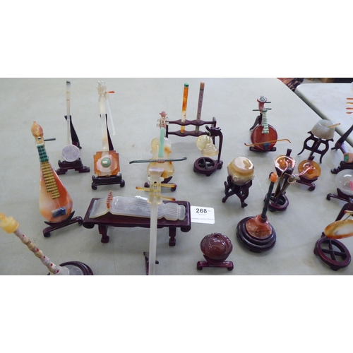 268 - Modern jade coloured and hardstone musical instruments with individual rosewood stands