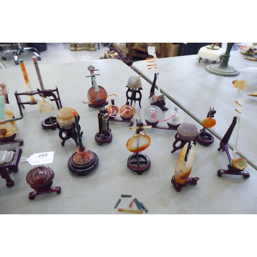 268 - Modern jade coloured and hardstone musical instruments with individual rosewood stands