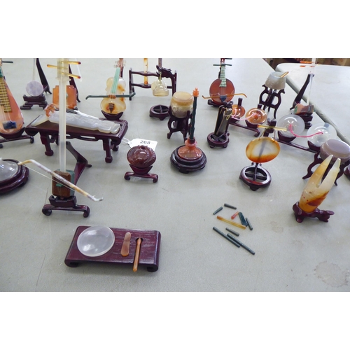 268 - Modern jade coloured and hardstone musical instruments with individual rosewood stands