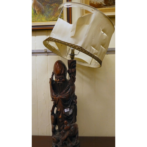 294 - A 20thC Chinese carved fruitwood table lamp, fashioned as an elderly man  27