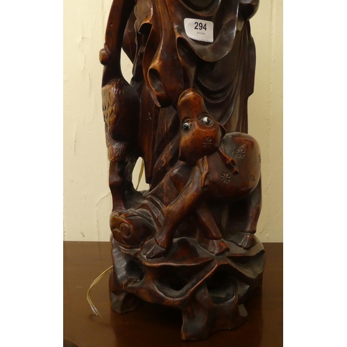 294 - A 20thC Chinese carved fruitwood table lamp, fashioned as an elderly man  27