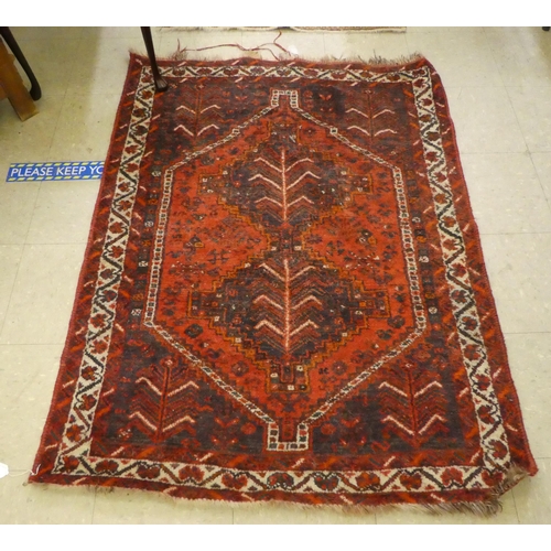 296 - A Persian rug with floral decoration, on a red ground  44