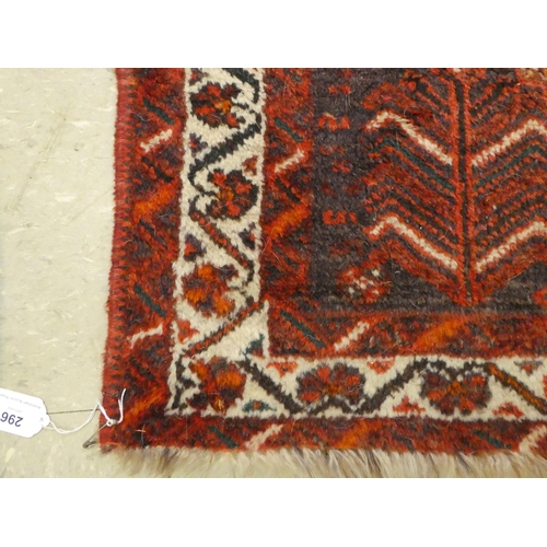 296 - A Persian rug with floral decoration, on a red ground  44